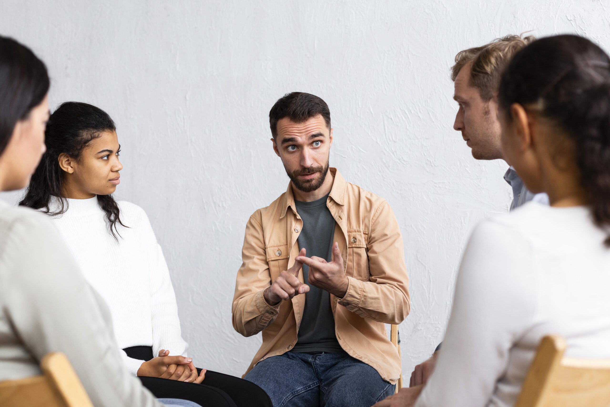 man-explaining-his-problems-group-therapy-session Mindset Coaching